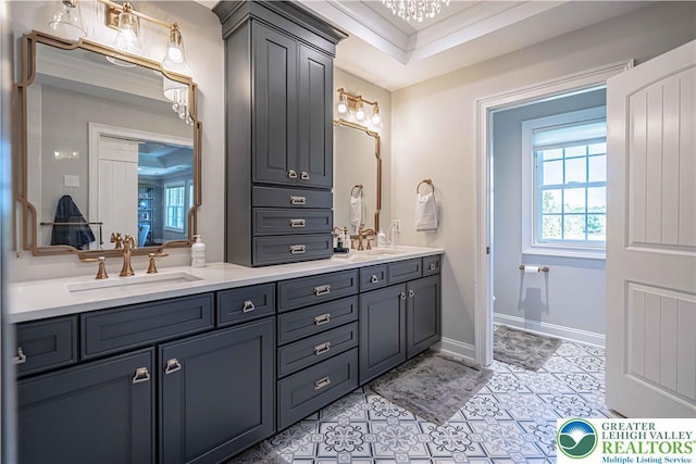 full bath featuring double vanity, tile patterned floors, and baseboards