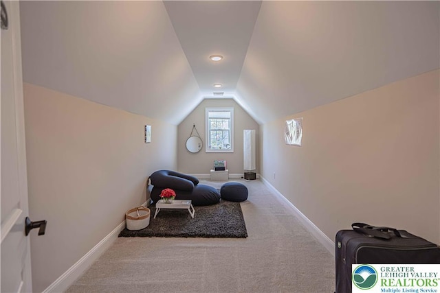 sitting room with vaulted ceiling, baseboards, and carpet flooring