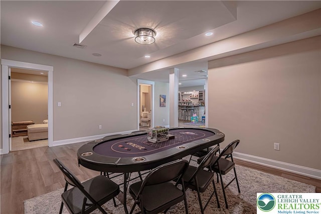 dining space featuring wood finished floors, recessed lighting, and baseboards