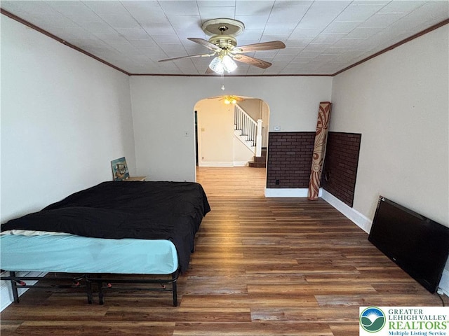 330 18th St, Allentown City, PA 18104 - bedroom featuring crown molding, arched walkways, wood finished floors, baseboards, and a ceiling fan