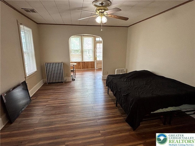 330 18th St, Allentown City, PA 18104 - bedroom with radiator, crown molding, dark wood-style flooring, arched walkways, and baseboards