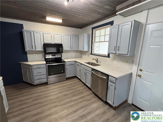 330 18th St, Allentown City, PA 18104 - kitchen with appliances with stainless steel finishes, gray cabinetry, a sink, light countertops, and wood finished floors