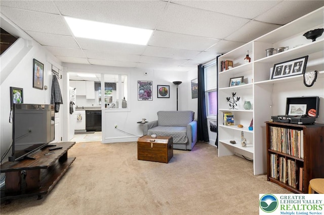 living area with light colored carpet and a drop ceiling