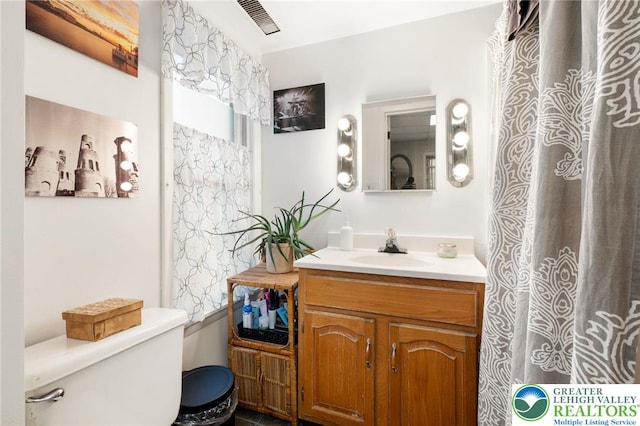 bathroom featuring toilet and vanity