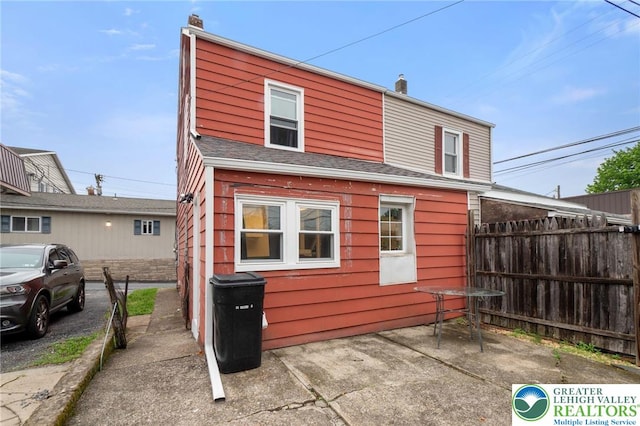 back of house with fence