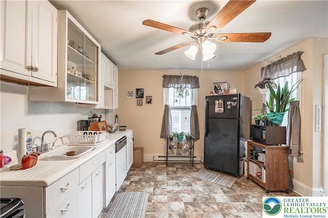 kitchen featuring black appliances, a sink, a baseboard heating unit, a ceiling fan, and light countertops