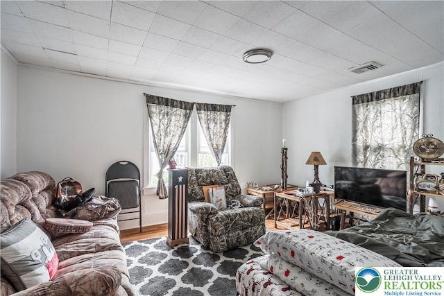 living area with healthy amount of natural light and wood finished floors