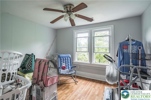 bedroom featuring wood finished floors, a ceiling fan, and baseboards