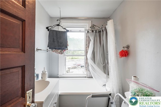 bathroom with vanity and a shower with shower curtain