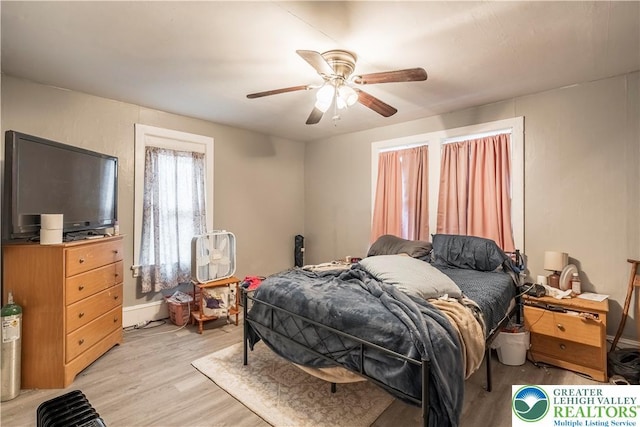 bedroom with light wood-style flooring and a ceiling fan