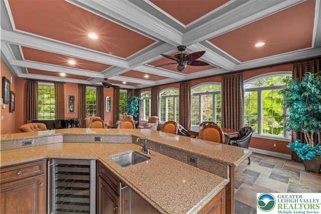 217 Rising Meadow Way, Middle Smithfield Twp, PA 18302 - kitchen featuring wine cooler, a sink, stone tile flooring, coffered ceiling, and ornamental molding