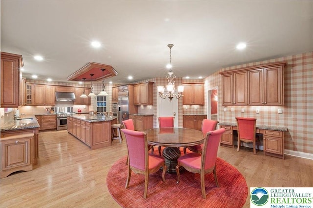 217 Rising Meadow Way, Middle Smithfield Twp, PA 18302 - dining space with light wood finished floors, a chandelier, wallpapered walls, and recessed lighting