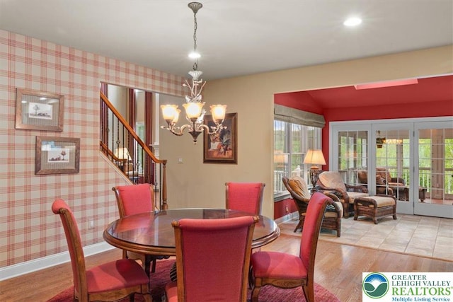 217 Rising Meadow Way, Middle Smithfield Twp, PA 18302 - dining room with french doors, wood finished floors, a chandelier, and stairway