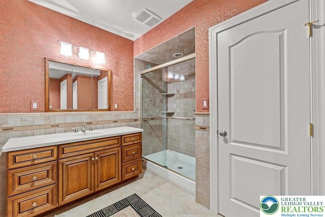 217 Rising Meadow Way, Middle Smithfield Twp, PA 18302 - full bath with a shower stall, tile walls, vanity, and wainscoting