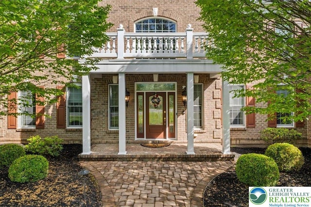 217 Rising Meadow Way, Middle Smithfield Twp, PA 18302 - property entrance featuring a balcony, a porch, and brick siding