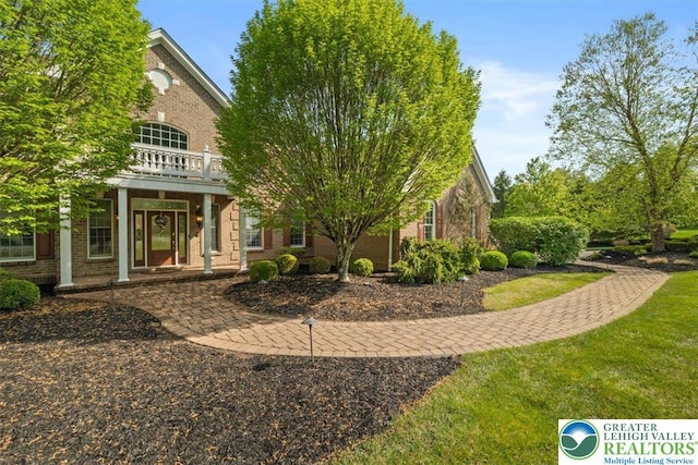 217 Rising Meadow Way, Middle Smithfield Twp, PA 18302 - rear view of house featuring brick siding and a porch