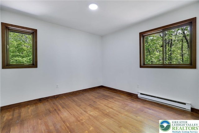 8210 Pine Grove, Stroud Twp, PA 18301 - spare room with a baseboard heating unit, wood finished floors, baseboards, and recessed lighting