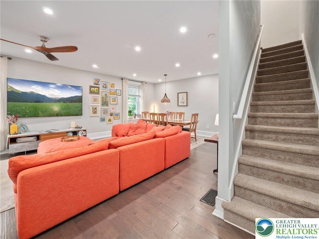 living area with stairs, recessed lighting, a ceiling fan, wood finished floors, and baseboards
