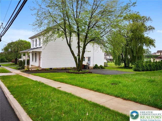 1942 Schadt Ave, Whitehall Twp, PA 18052 - view of side of home featuring a lawn