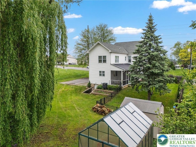 1942 Schadt Ave, Whitehall Twp, PA 18052 - rear view of property with a lawn and a sunroom