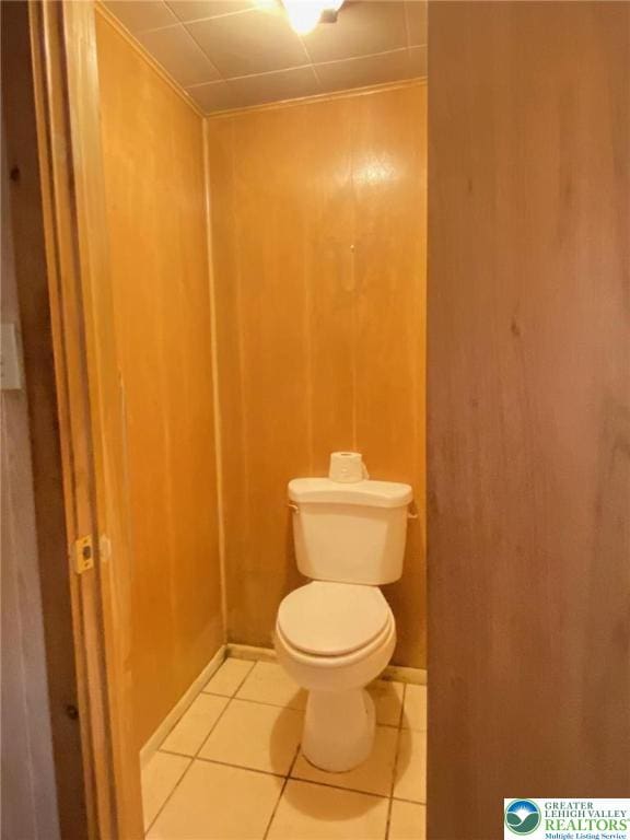 bathroom featuring toilet and tile patterned flooring