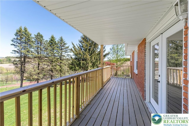 wooden deck with a yard
