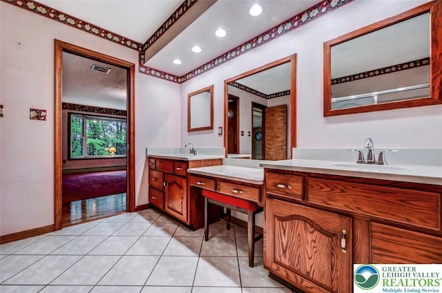 bathroom with two vanities, recessed lighting, baseboards, and tile patterned floors