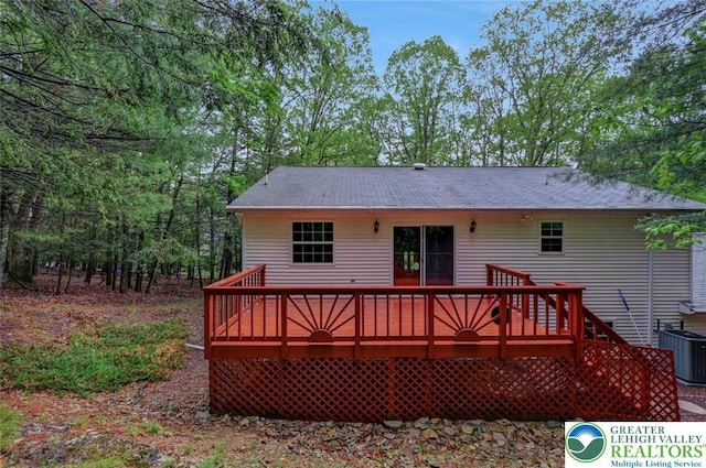rear view of property featuring central AC and a deck