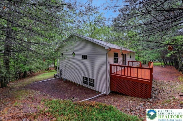 rear view of house with a wooden deck
