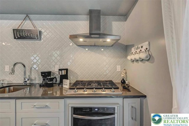 304 Ruger Ln, Coolbaugh Twp, PA 18466 - kitchen featuring stainless steel appliances, a sink, wall chimney range hood, backsplash, and dark countertops