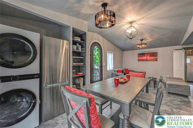 304 Ruger Ln, Coolbaugh Twp, PA 18466 - dining room featuring stacked washing machine and dryer, vaulted ceiling, light marble finish flooring, and a chandelier