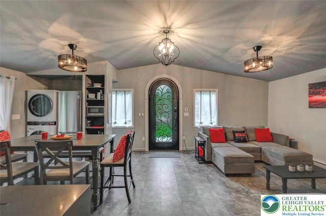 304 Ruger Ln, Coolbaugh Twp, PA 18466 - dining room with estacked washer and dryer, a chandelier, vaulted ceiling, and baseboards