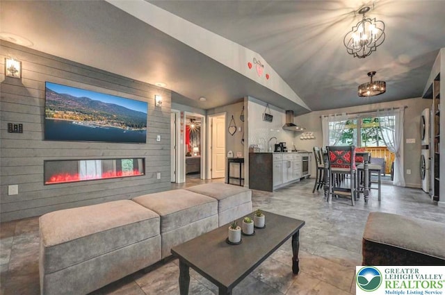 304 Ruger Ln, Coolbaugh Twp, PA 18466 - living area with vaulted ceiling, a glass covered fireplace, and a chandelier