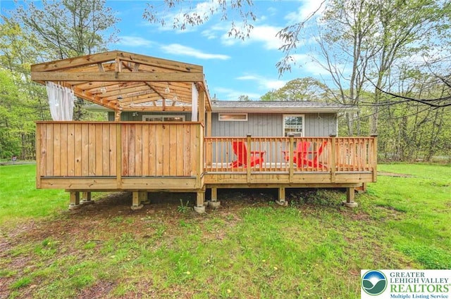 304 Ruger Ln, Coolbaugh Twp, PA 18466 - rear view of house featuring a deck and a lawn