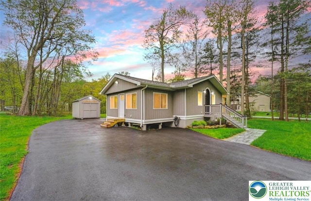 304 Ruger Ln, Coolbaugh Twp, PA 18466 - single story home with a front yard, asphalt driveway, and a detached garage