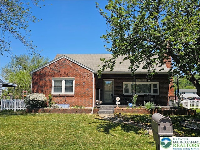 view of front of property featuring brick siding and roof with shingles