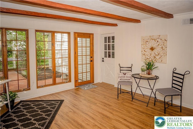 entryway featuring beamed ceiling and wood finished floors