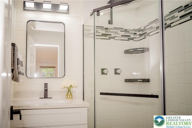 full bathroom with a stall shower and vanity