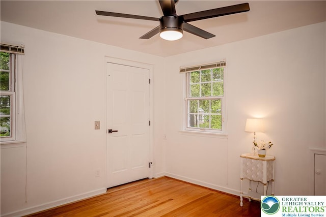 unfurnished bedroom with light wood-style flooring, baseboards, and a ceiling fan
