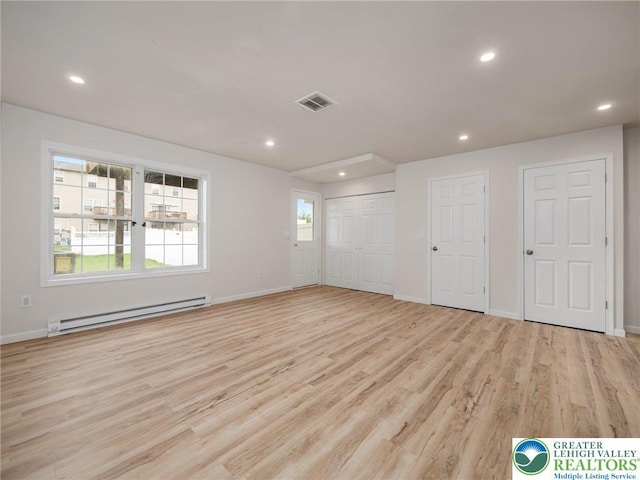 unfurnished bedroom featuring a baseboard radiator, light wood-style flooring, baseboards, and recessed lighting