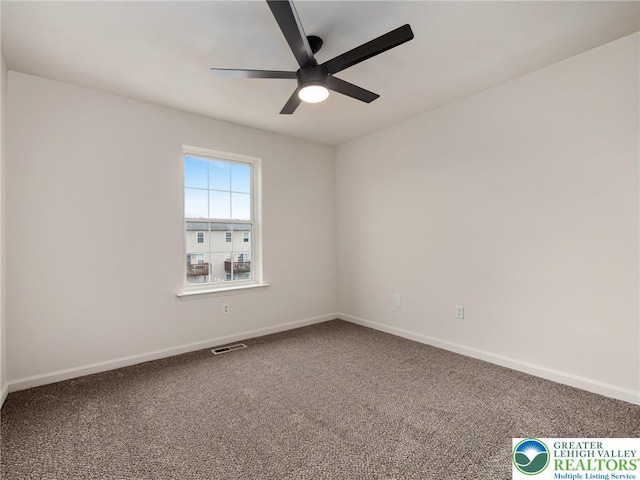 unfurnished room featuring a ceiling fan, carpet, and baseboards