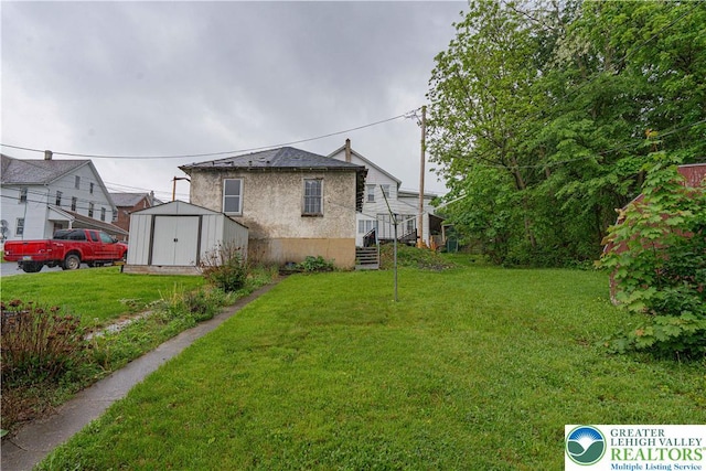 603 S Main St, Bangor Borough, PA 18013 - rear view of house featuring a storage shed, a lawn, and an outdoor structure