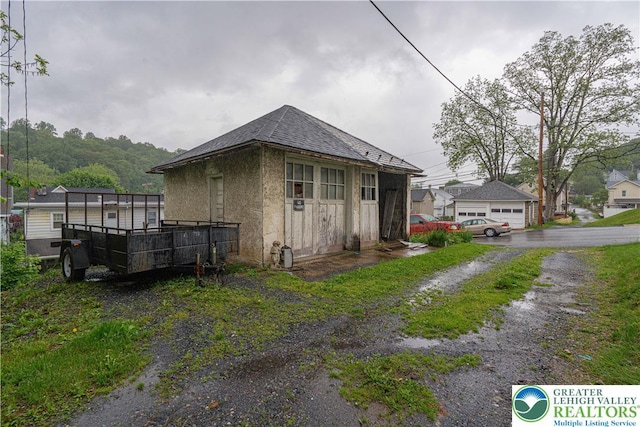 603 S Main St, Bangor Borough, PA 18013 - view of property exterior with a shingled roof and stucco siding