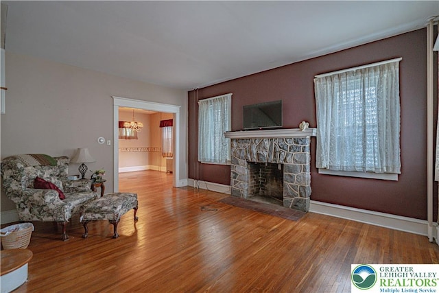 603 S Main St, Bangor Borough, PA 18013 - living room with wood finished floors, a chandelier, a fireplace, and baseboards