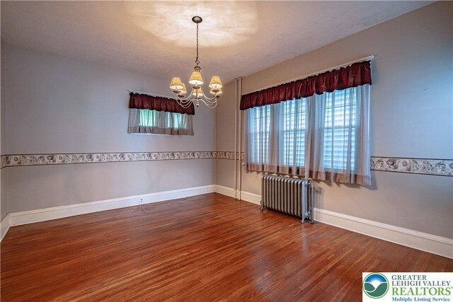 603 S Main St, Bangor Borough, PA 18013 - spare room with radiator, wood finished floors, a chandelier, and baseboards