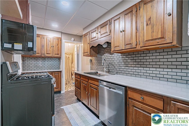 603 S Main St, Bangor Borough, PA 18013 - kitchen with dishwasher, gas range, a sink, decorative backsplash, and light countertops