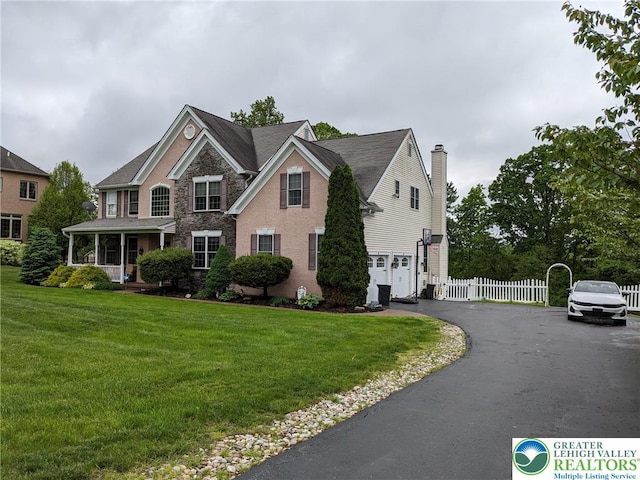 131 Winding Way, Washington Twp, PA 18013 - view of front facade with a garage, driveway, stone siding, and covered porch