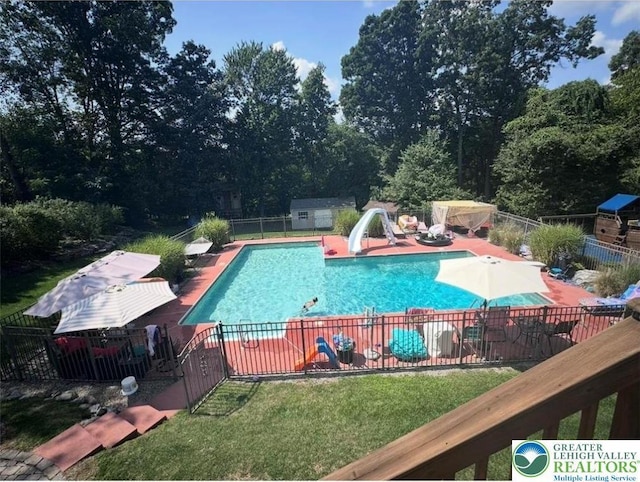 131 Winding Way, Washington Twp, PA 18013 - view of swimming pool with a water slide, fence, an outdoor structure, and a patio area