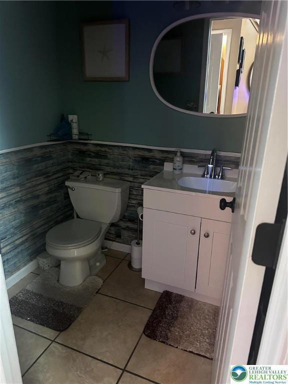 131 Winding Way, Washington Twp, PA 18013 - bathroom featuring tile patterned floors, toilet, vanity, and a wainscoted wall