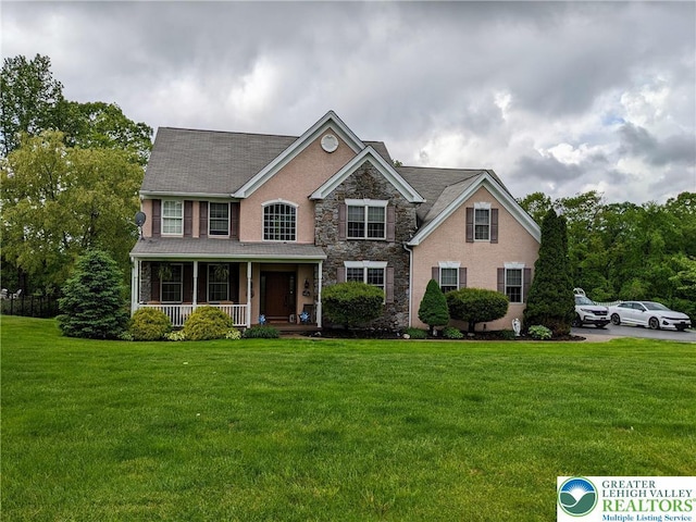 131 Winding Way, Washington Twp, PA 18013 - view of front facade featuring stone siding, a porch, a front yard, and stucco siding